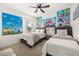 Bright bedroom featuring two twin beds, carpeted floor and Mario themed wall art at 5117 Oakbourne Ave, Davenport, FL 33837