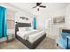 Comfortable bedroom features carpet floors, grey upholstered headboard, bedside tables and plenty of natural light at 5117 Oakbourne Ave, Davenport, FL 33837