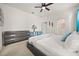 Bright bedroom featuring carpet floors, light grey furnishings, plenty of windows and ensuite bathroom at 5117 Oakbourne Ave, Davenport, FL 33837