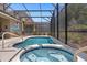 Enclosed Pool with attached hot tub and patio at 5117 Oakbourne Ave, Davenport, FL 33837