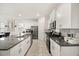 This kitchen features stainless steel appliances, granite countertops, and white cabinets at 5117 Oakbourne Ave, Davenport, FL 33837