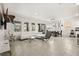 Open-concept living area with tile floors, modern furniture, and a dining table at 5117 Oakbourne Ave, Davenport, FL 33837