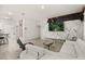 Bright living room with white tile flooring and marble accent wall with television and seating at 5117 Oakbourne Ave, Davenport, FL 33837