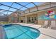 Enclosed pool with chairs and cartoon wall art at 5117 Oakbourne Ave, Davenport, FL 33837