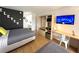 A modern bedroom features two beds, a sleek kitchenette, desk area, and accent wall at 5245 W Irlo Bronson Memorial Hwy # 192, Kissimmee, FL 34746