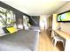 Bright bedroom featuring two beds, a modern desk and chair, and a large wall-mounted TV at 5245 W Irlo Bronson Memorial Hwy # 192, Kissimmee, FL 34746