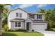 Charming two-story home featuring a two-car garage, landscaped yard, and gray color palette at 5457 Catmint Dr, Lake Hamilton, FL 33851
