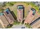 An aerial view shows three houses with private screened-in pools, surrounded by well-maintained landscaping and mature trees at 5512 Solterra Cir, Davenport, FL 33837