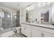 A bathroom with a glass shower, gray tiling, a gray countertop, and a double-sink at 5512 Solterra Cir, Davenport, FL 33837