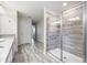 Modern bathroom design features stone tiled floors, a glass-enclosed shower, and a vanity area at 5512 Solterra Cir, Davenport, FL 33837