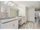Bathroom boasts dual vanities, stone countertops, and neutral tones for a calming space at 5512 Solterra Cir, Davenport, FL 33837