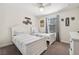 This is a bedroom with two beds, movie-themed wall art, carpet, and a ceiling fan at 5512 Solterra Cir, Davenport, FL 33837