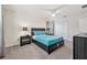 This bedroom features carpet, a ceiling fan, and a bed with gray nightstands and drawers beneath the bed at 5512 Solterra Cir, Davenport, FL 33837
