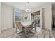 Elegant dining room features a modern table, stylish chairs, and a chandelier, perfect for entertaining guests at 5512 Solterra Cir, Davenport, FL 33837