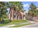 Charming two-story home featuring tropical landscaping, a brick driveway, and an attached garage at 5512 Solterra Cir, Davenport, FL 33837