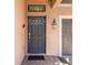 Inviting front entry with dark wood door, brick pavers, and a charming carriage lamp at 5512 Solterra Cir, Davenport, FL 33837