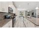 Modern open kitchen with stainless steel appliances, granite counters, a center island, and stylish backsplash at 5512 Solterra Cir, Davenport, FL 33837