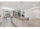 Open kitchen boasts an island with granite countertops and stainless steel appliances, perfect for modern living at 5512 Solterra Cir, Davenport, FL 33837