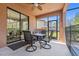 Relaxing covered patio featuring an outdoor dining set with views of the screened pool and backyard at 5512 Solterra Cir, Davenport, FL 33837