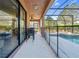 Covered patio with outdoor seating overlooks the screened pool and backyard, ideal for outdoor dining at 5512 Solterra Cir, Davenport, FL 33837