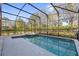 Inviting screened-in pool and spa are a perfect retreat for enjoying the beautiful outdoors at 5512 Solterra Cir, Davenport, FL 33837