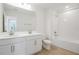 Bright bathroom featuring double sink vanity, wood look floors, and combo tub and shower at 570 Summit River Dr, Apopka, FL 32712