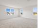 Bright, carpeted bedroom with multiple windows providing lots of natural light and neighborhood views at 570 Summit River Dr, Apopka, FL 32712