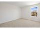 Bedroom featuring neutral carpeting, white walls and a large window that provides natural light at 570 Summit River Dr, Apopka, FL 32712
