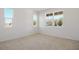 Bright, empty bedroom featuring multiple windows providing lots of natural light and carpet flooring at 570 Summit River Dr, Apopka, FL 32712
