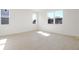 Spacious, empty bedroom featuring multiple windows providing lots of natural light and tile flooring at 570 Summit River Dr, Apopka, FL 32712