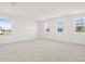 Large bedroom with three windows and carpet, providing ample light and space at 570 Summit River Dr, Apopka, FL 32712