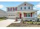 Two-story home with stone accents, red shutters, front porch, and attached two-car garage at 570 Summit River Dr, Apopka, FL 32712