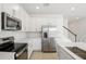 Modern kitchen with white cabinetry, stainless steel appliances, island, and tile flooring at 570 Summit River Dr, Apopka, FL 32712