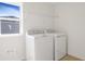 Functional laundry room with new washer and dryer and wire rack shelving for convenient storage at 570 Summit River Dr, Apopka, FL 32712