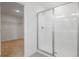 Bathroom with a walk-in shower featuring clear glass doors and ceramic tile surround, next to walk-in closet at 570 Summit River Dr, Apopka, FL 32712