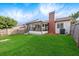 View of backyard showing porch, chimney, and lawn at 623 Lake Dexter Cir, Winter Haven, FL 33884