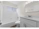 This bathroom features a shower-tub combo, white vanity, and modern fixtures at 623 Lake Dexter Cir, Winter Haven, FL 33884