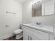 Modern bathroom featuring a white vanity, toilet and faucet at 623 Lake Dexter Cir, Winter Haven, FL 33884