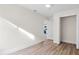 Bright bedroom featuring wood-look floors, neutral walls and walk-in closet at 623 Lake Dexter Cir, Winter Haven, FL 33884