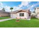 Charming single-story home with green grass and a driveway leading to an attached garage at 623 Lake Dexter Cir, Winter Haven, FL 33884