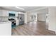 Open kitchen with stainless steel appliances, white cabinets and wood-look flooring at 623 Lake Dexter Cir, Winter Haven, FL 33884