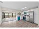 Modern kitchen with white cabinets, stainless steel appliances, and adjacent screened patio at 623 Lake Dexter Cir, Winter Haven, FL 33884