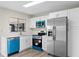 Bright kitchen featuring stainless steel appliances, white cabinets, and vibrant turquoise accents at 623 Lake Dexter Cir, Winter Haven, FL 33884