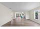 Open-concept living room with hardwood floors leads to a bright kitchen and screened in patio at 623 Lake Dexter Cir, Winter Haven, FL 33884