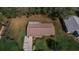 Aerial view of a home, highlighting the roof, yard, landscaping, and driveway at 6449 Eve St, St Cloud, FL 34771
