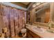 Bathroom featuring a sink, toilet, shower with curtain, and decorative accents at 6449 Eve St, St Cloud, FL 34771