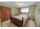 Simple bedroom featuring a wooden bed frame, neutral walls and carpet, and closet with louvered doors at 6449 Eve St, St Cloud, FL 34771