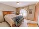 Comfortable bedroom with neutral walls, cozy textiles, and natural light from the window at 6449 Eve St, St Cloud, FL 34771