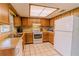 Functional kitchen with ample cabinet space, standard appliances, and tile flooring at 6449 Eve St, St Cloud, FL 34771
