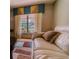Comfortable living room seating area with natural light streaming through the window at 6449 Eve St, St Cloud, FL 34771